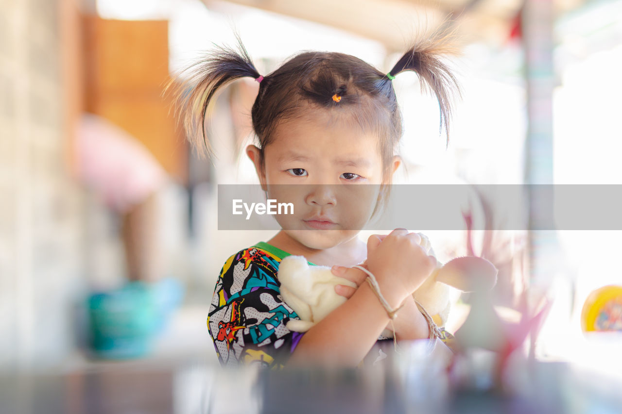 Portrait of cute girl with toy