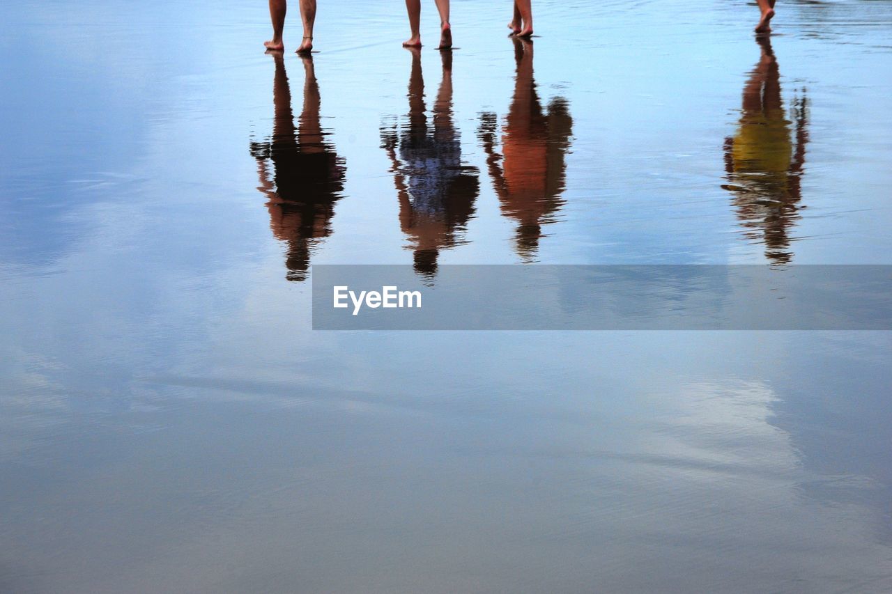 Reflection of people on the beach