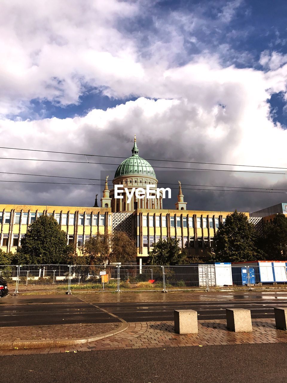 CHURCH AGAINST CLOUDY SKY IN CITY