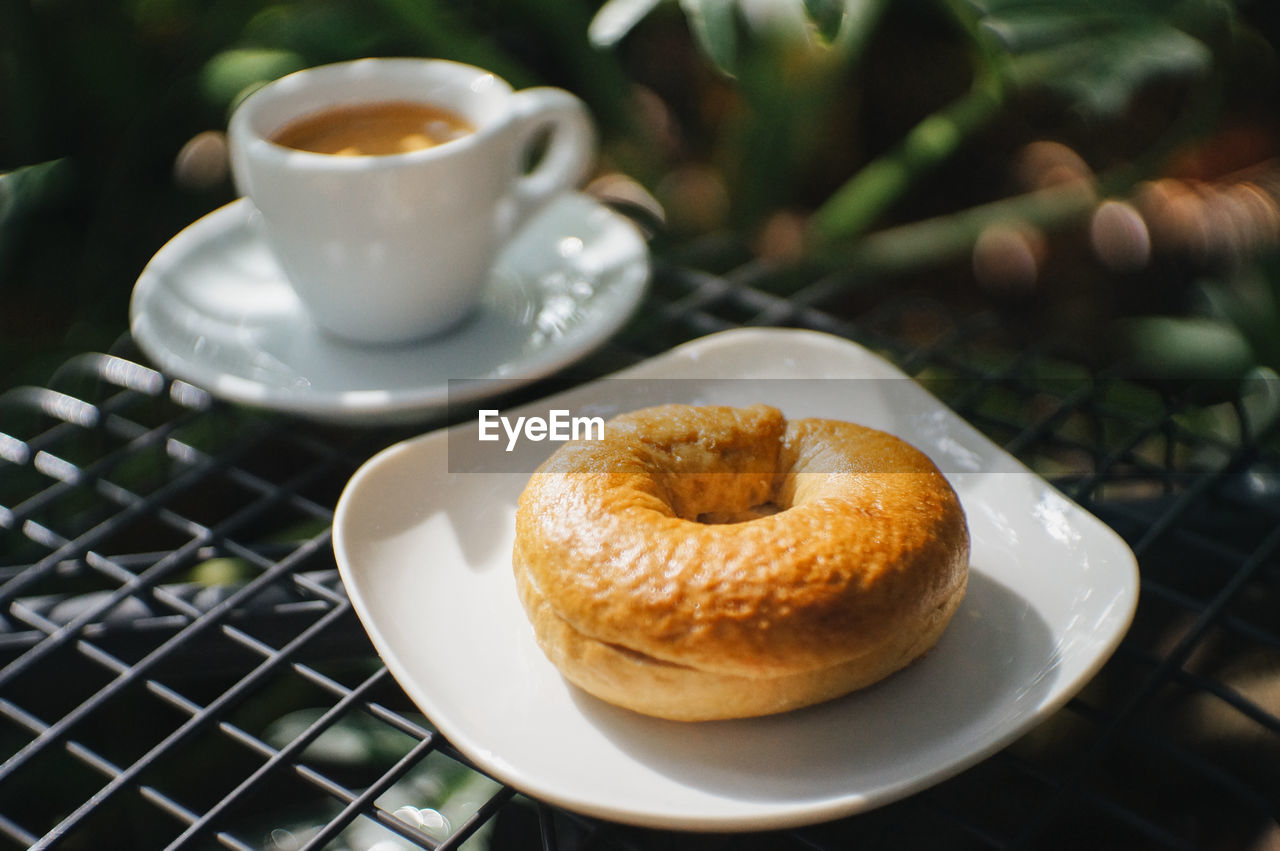 Close-up of homemade bagels and l coffee espresso on a gray chair natural background