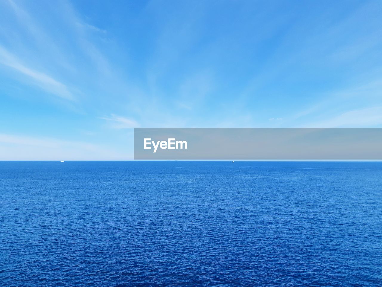 Scenic view of sea against blue sky