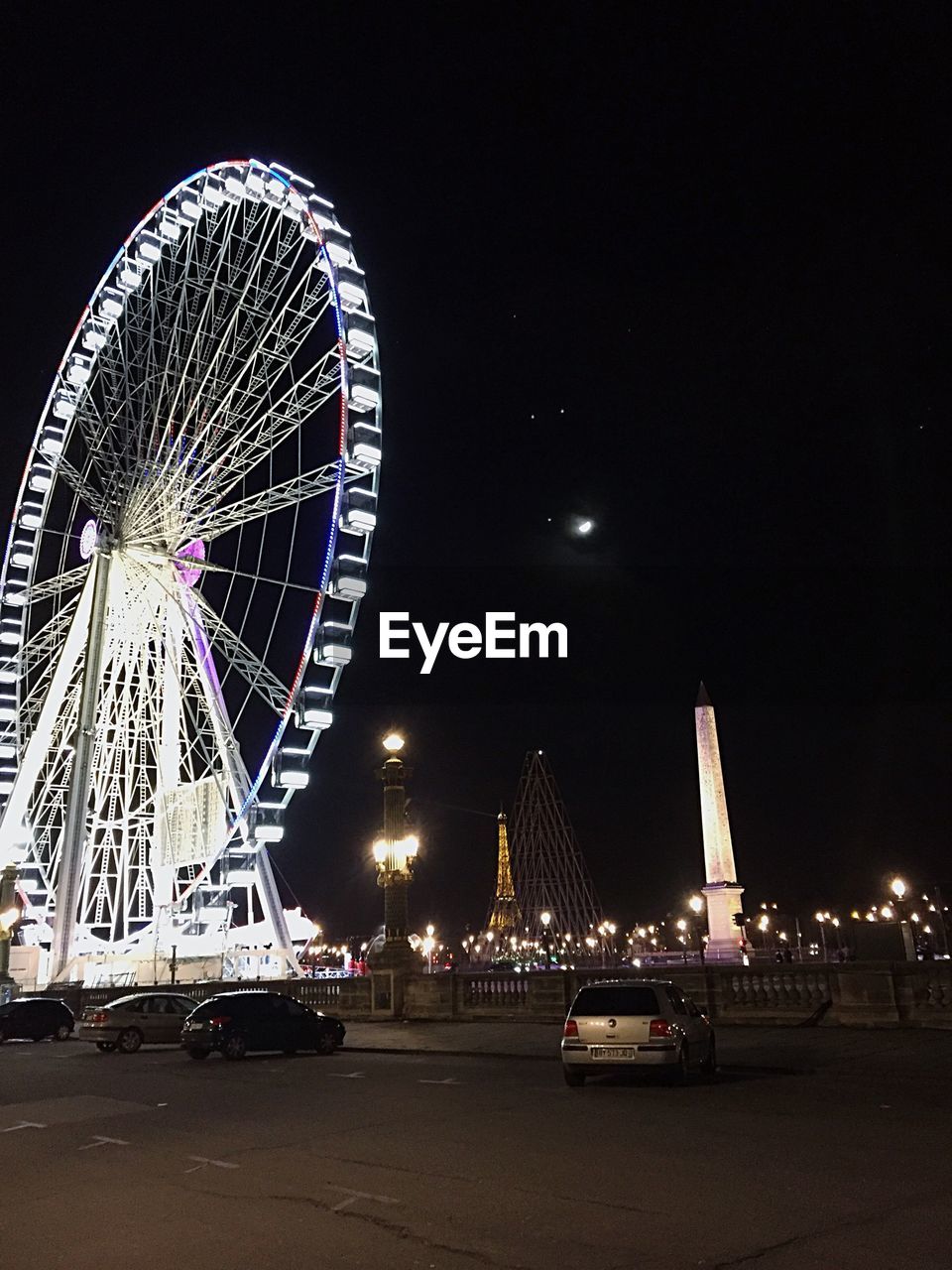 Ferris wheel at place de la concorde against sky at night