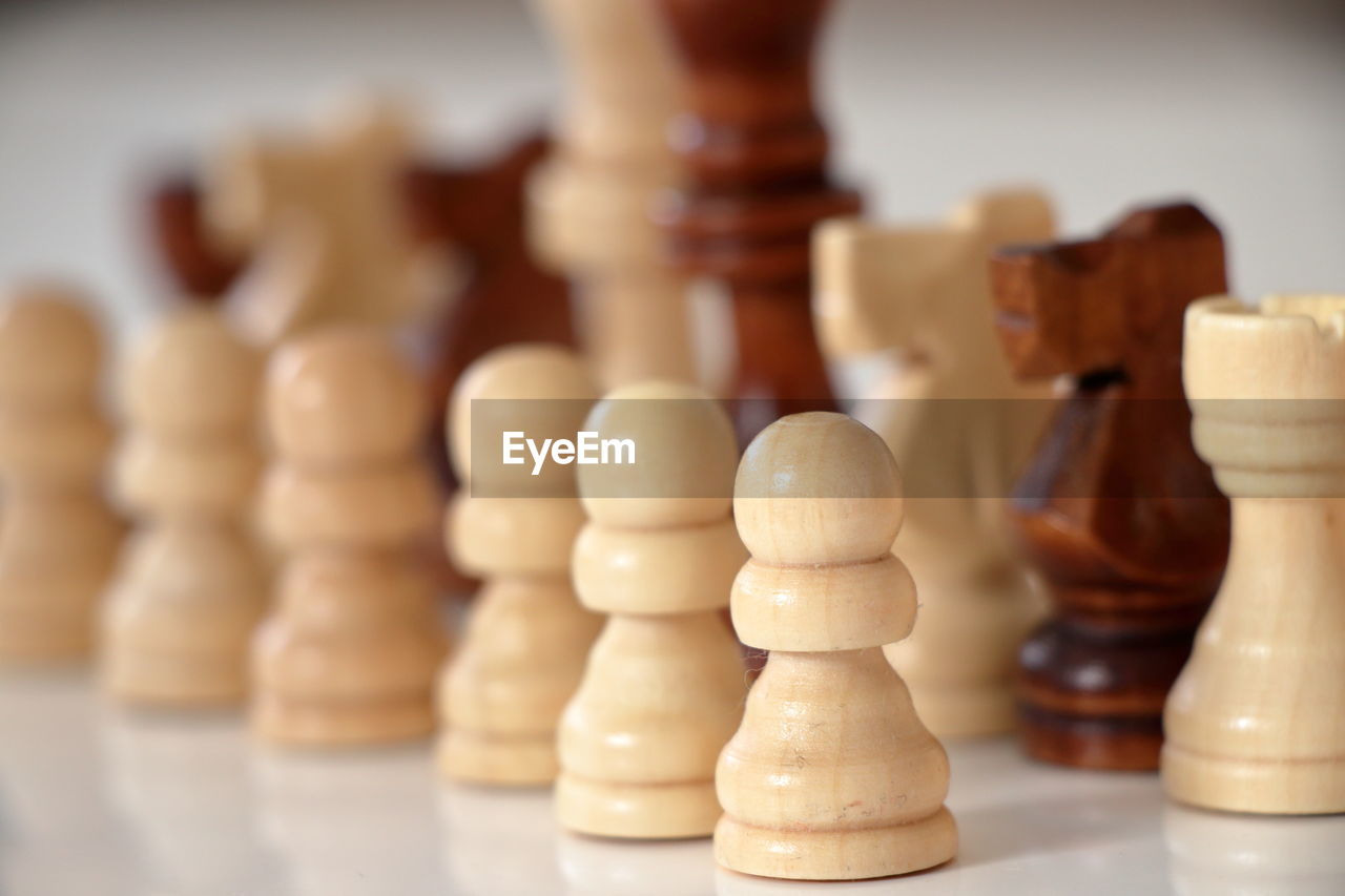 Close-up of wooden chess pieces on table