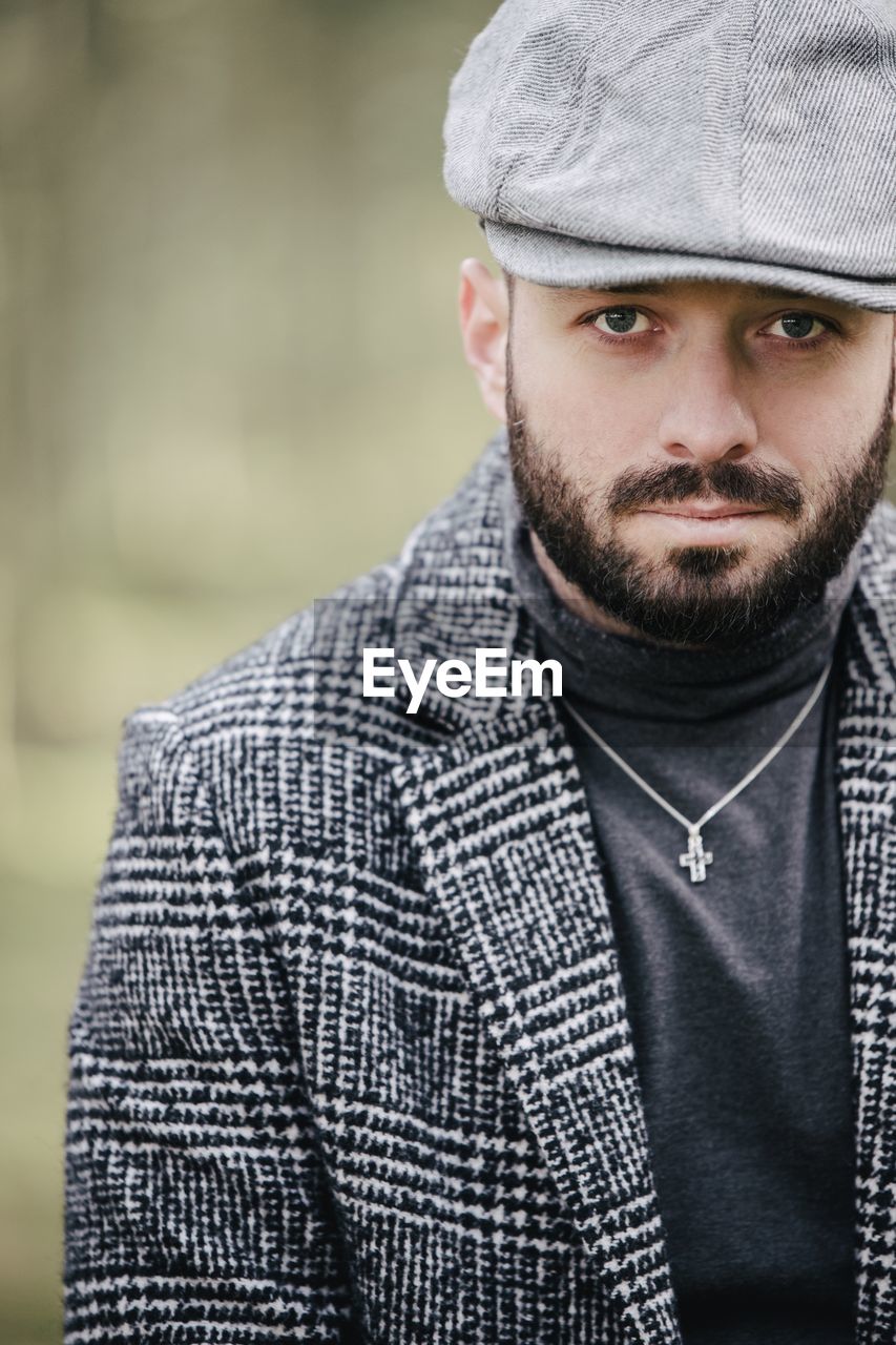 Portrait of man wearing hat standing outdoors