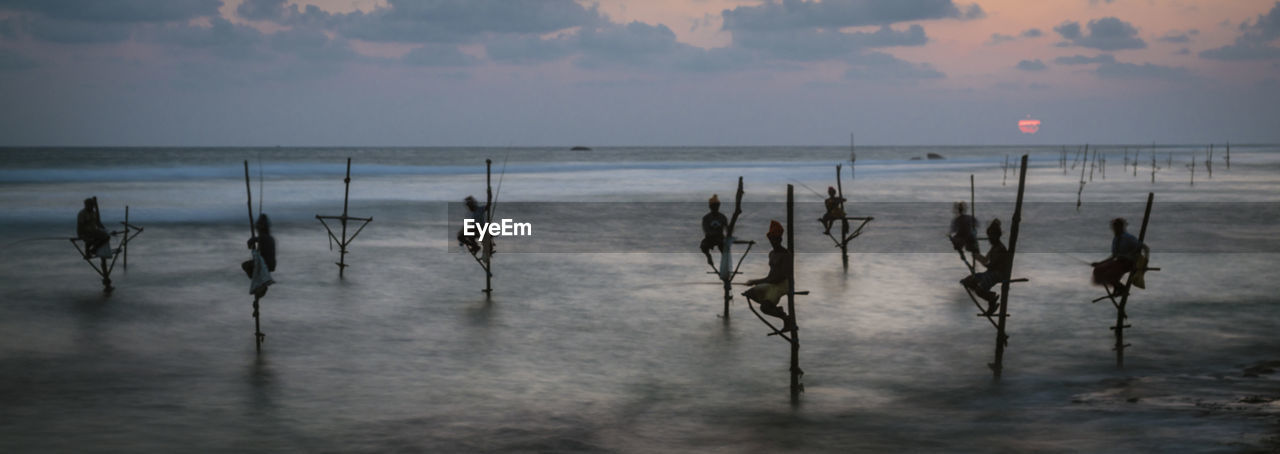 PANORAMIC VIEW OF BEACH AGAINST SKY DURING SUNSET