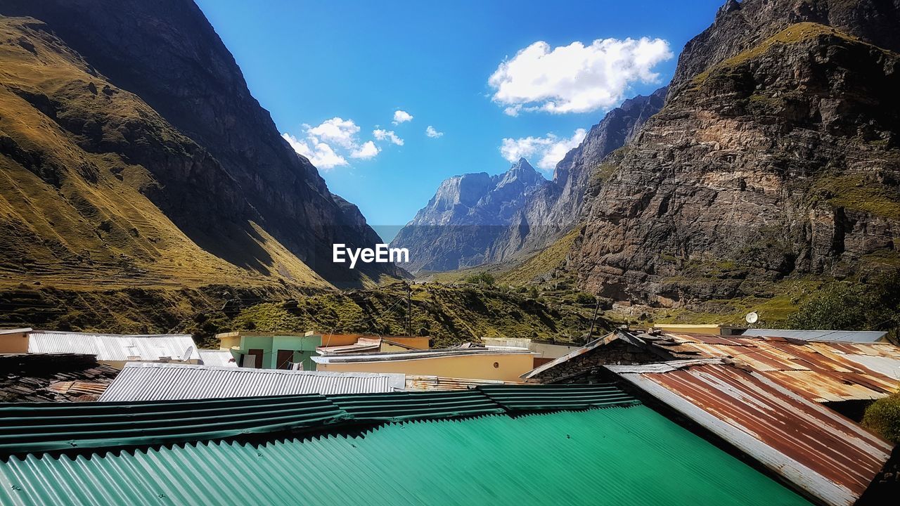 Panoramic view of buildings and mountains against sky