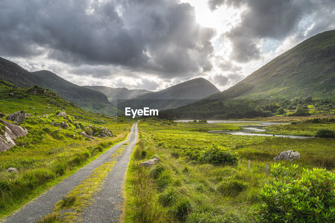 Country road leading trough black valley,  macgillycuddys reeks mountains, ring of kerry, ireland