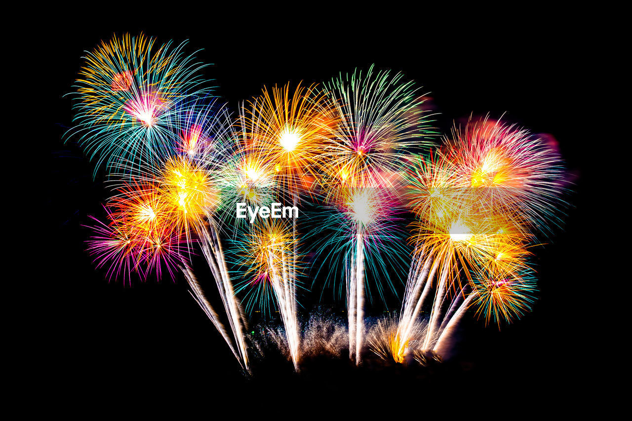 Low angle view of firework display against sky at night