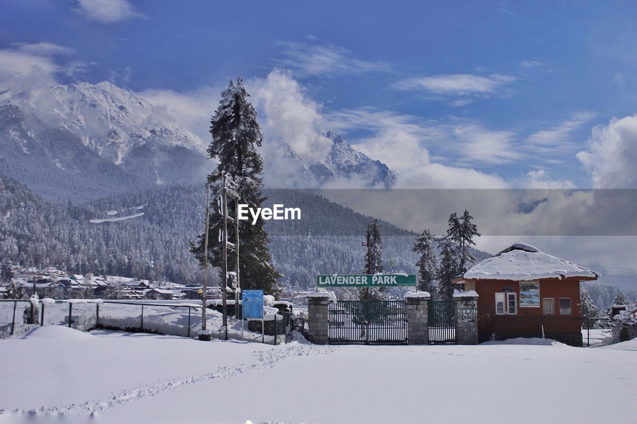 Houses on snowcapped mountain against sky