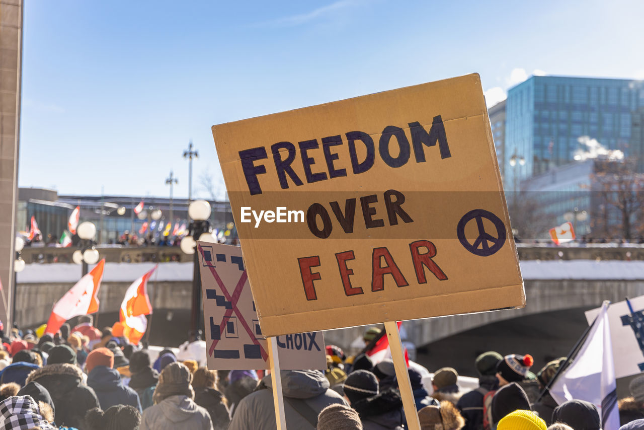 crowd, protest, protestor, group of people, large group of people, architecture, communication, text, city, education, building exterior, adult, social issues, sign, day, outdoors, banner, women, street, sky, men, built structure