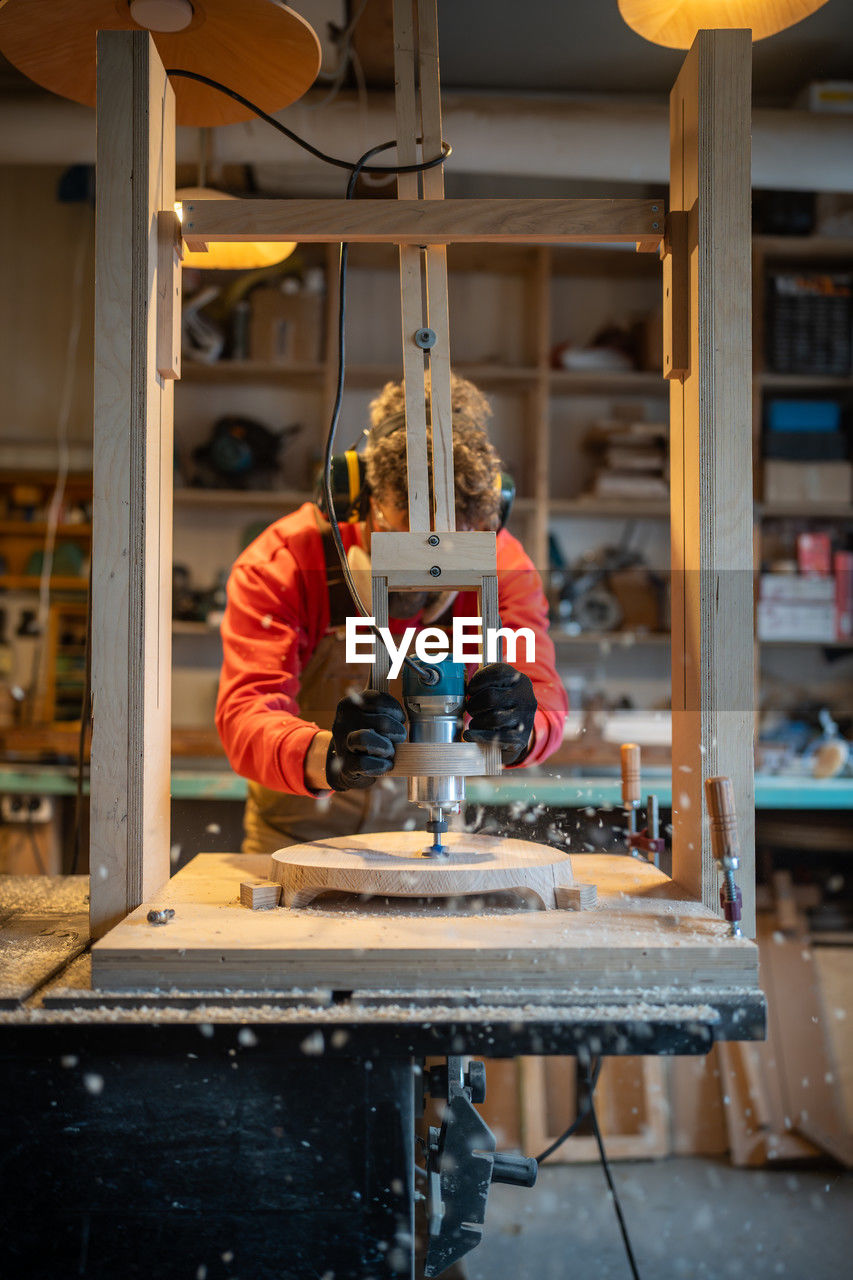 midsection of man working at workshop