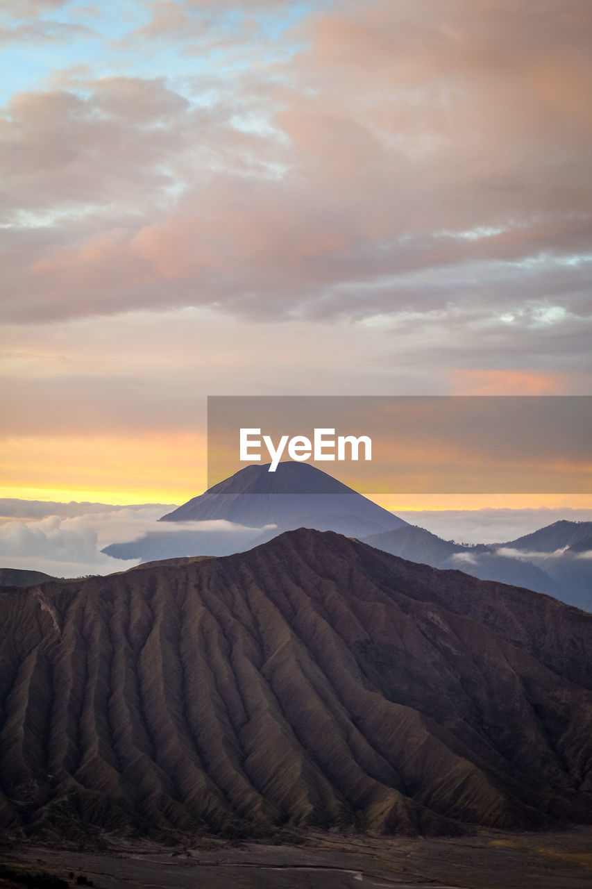 Scenic view of arid landscape against sky during sunrise in bromo tengger semeru national park