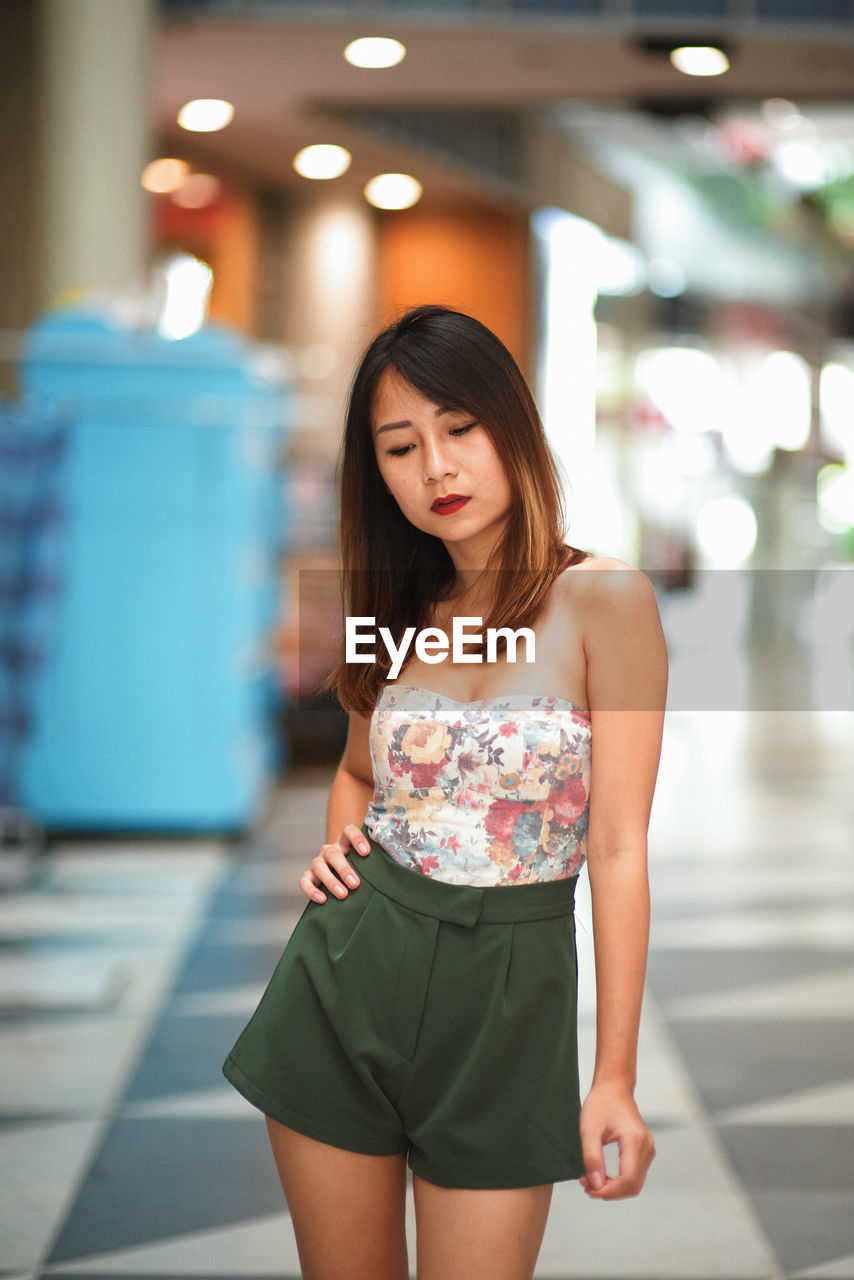 Thoughtful woman standing on floor