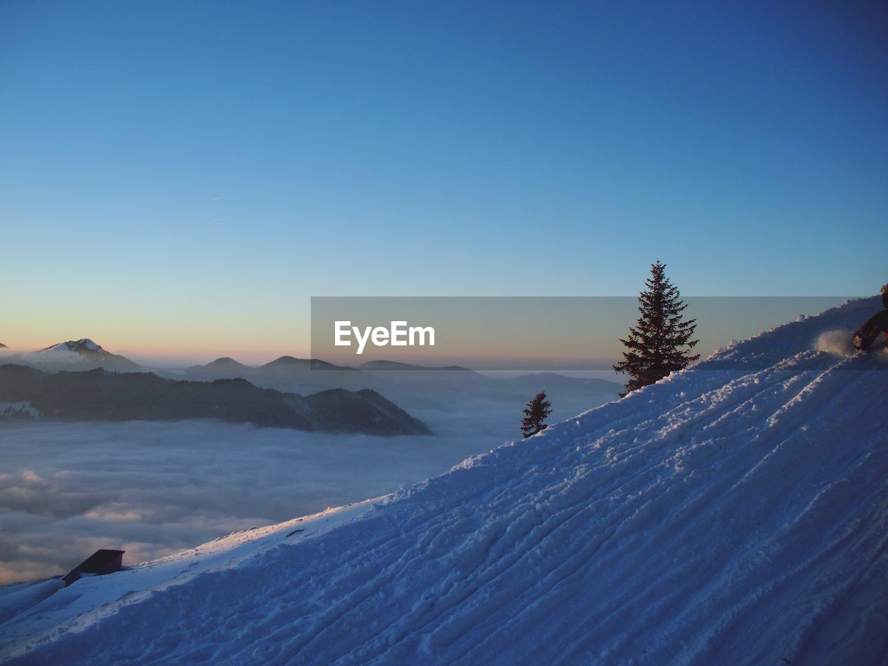 Scenic view of snowcapped mountains against clear blue sky