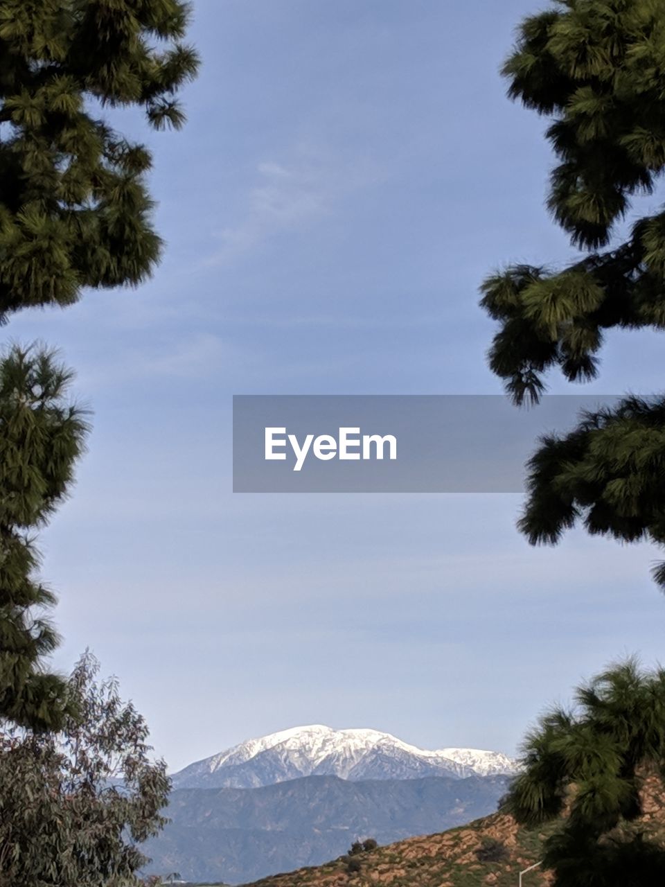 Scenic view of snow covered mountain against sky