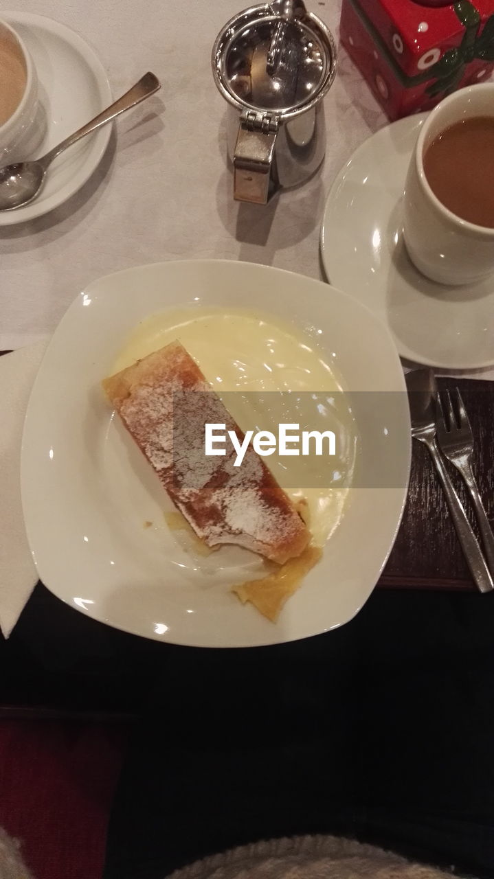 HIGH ANGLE VIEW OF CAKE SERVED ON TABLE