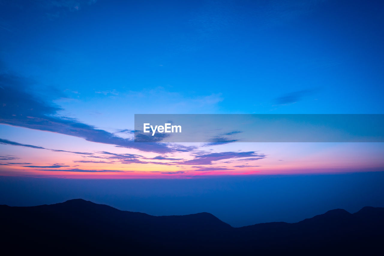 SCENIC VIEW OF SILHOUETTE MOUNTAINS AGAINST SKY DURING SUNSET