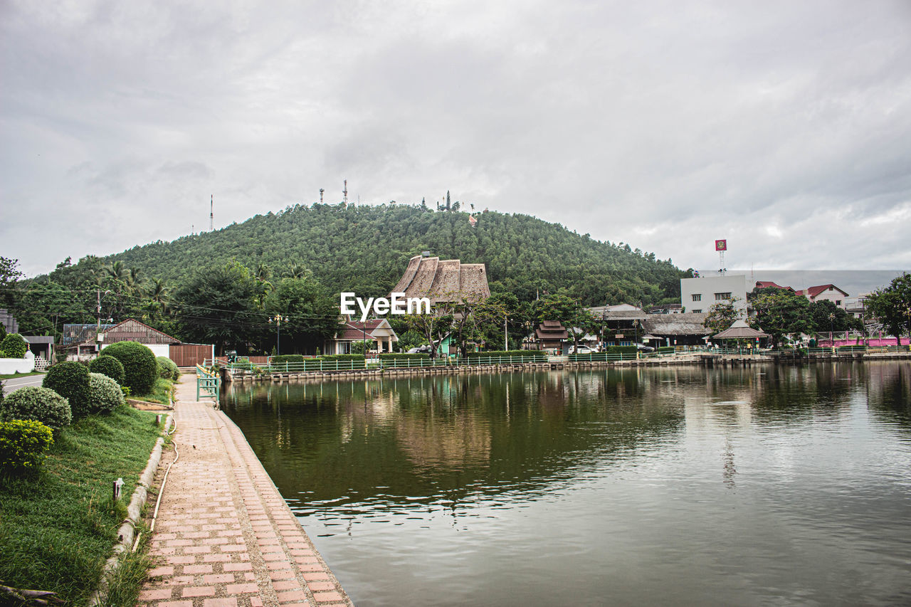 SCENIC VIEW OF LAKE BY BUILDING AGAINST SKY