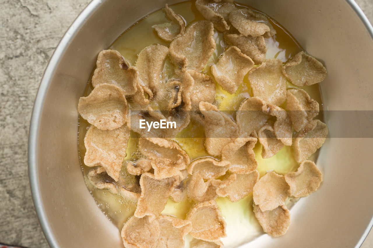 Directly above shot of potato chips in wok on table