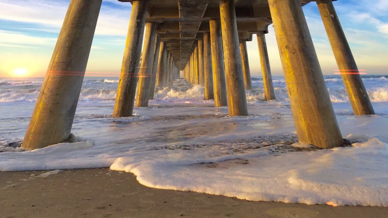 Scenic view of pier at sunset