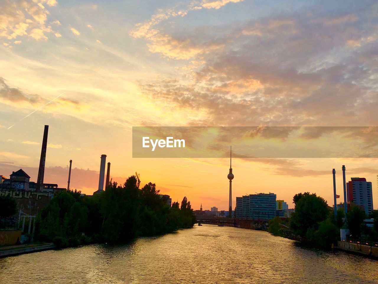 View of buildings against cloudy sky during sunset