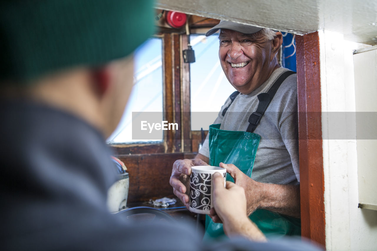 Fisherman getting cup of coffee