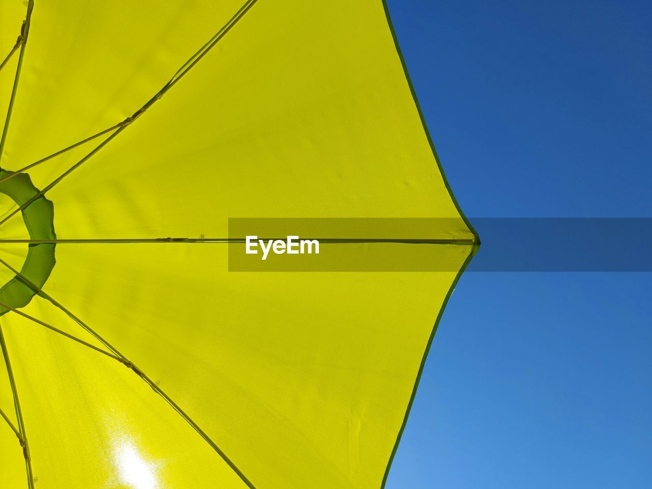 LOW ANGLE VIEW OF YELLOW UMBRELLA AGAINST CLEAR SKY