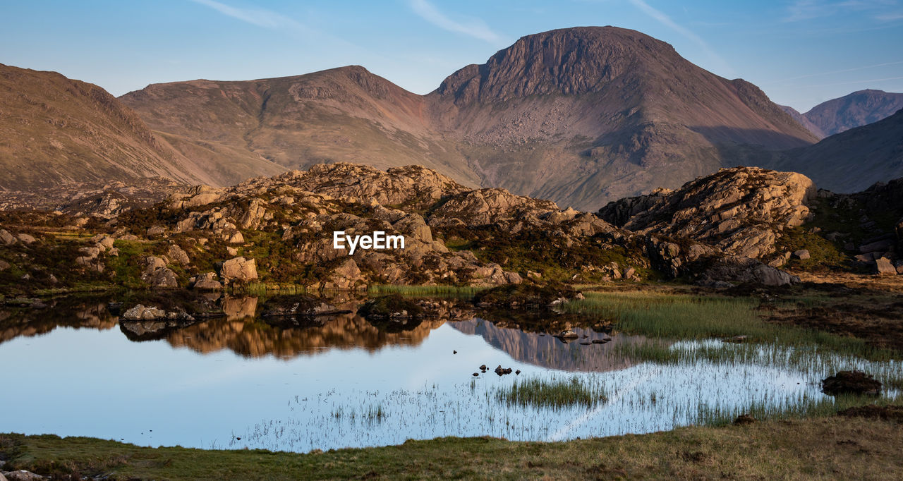 The evening light on the lakeland mountain of great gable reflecting in innominate tarn