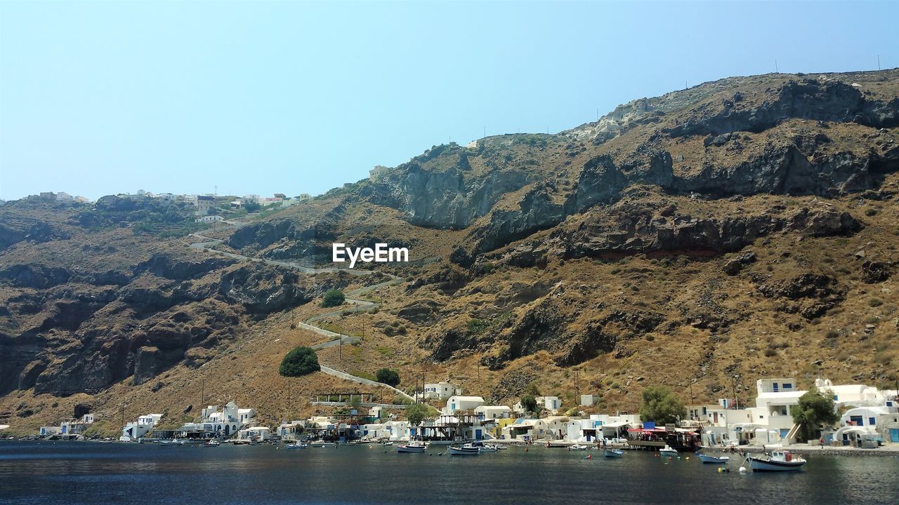 SCENIC VIEW OF SEA AND MOUNTAIN AGAINST CLEAR SKY