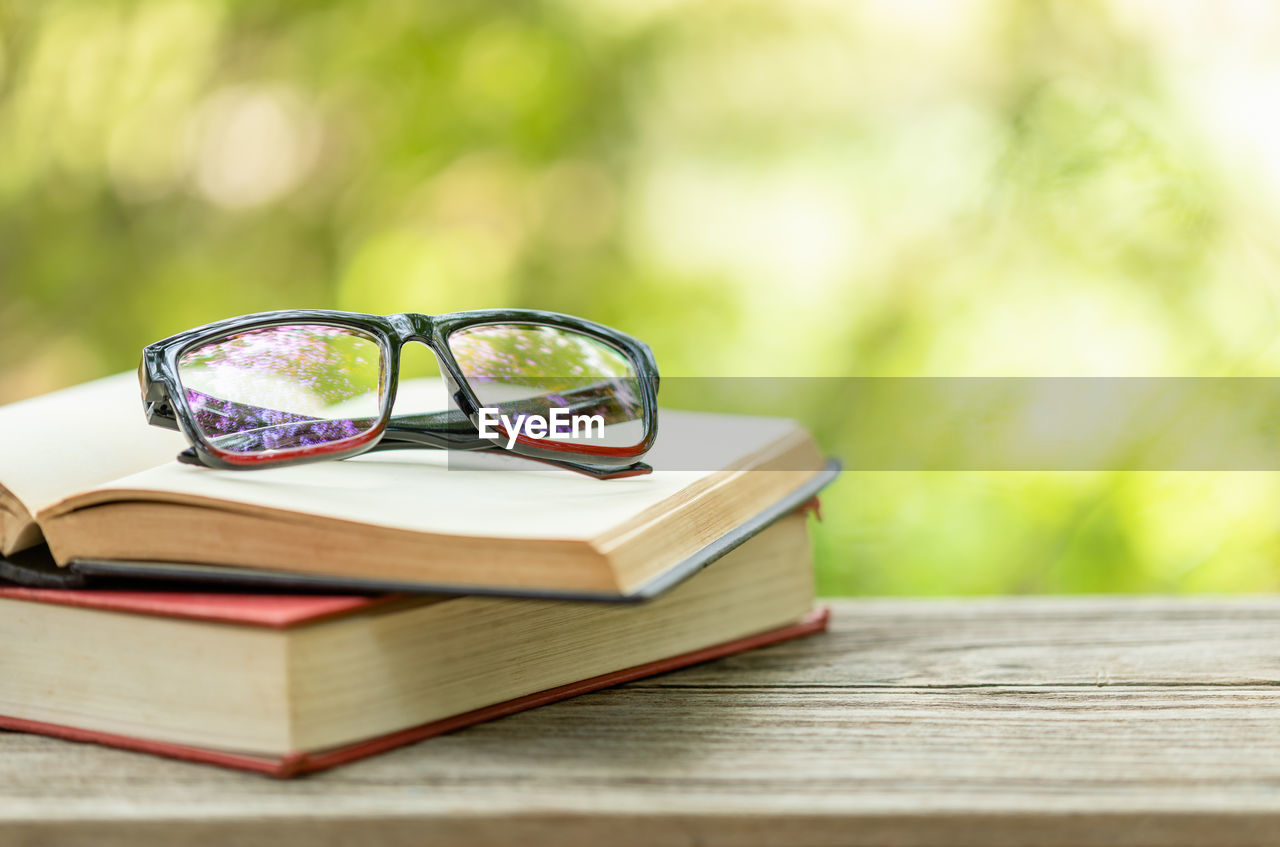 CLOSE-UP OF EYEGLASSES ON TABLE