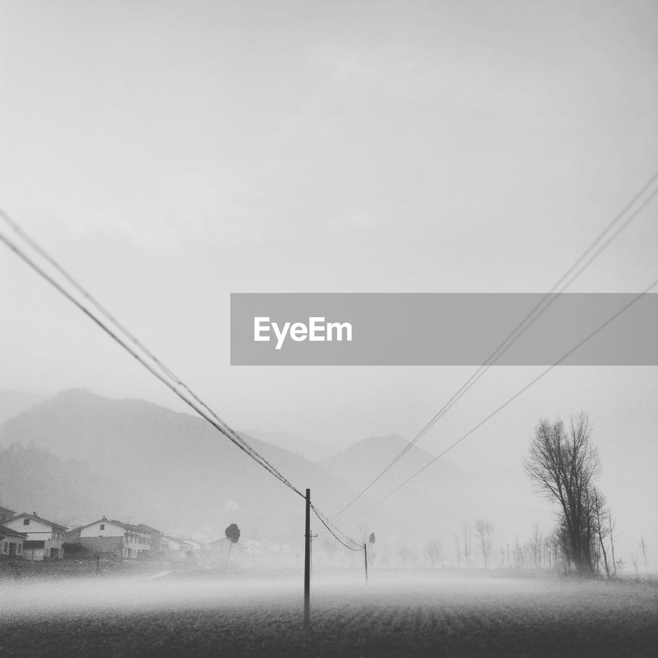 Electricity pylon on field against sky