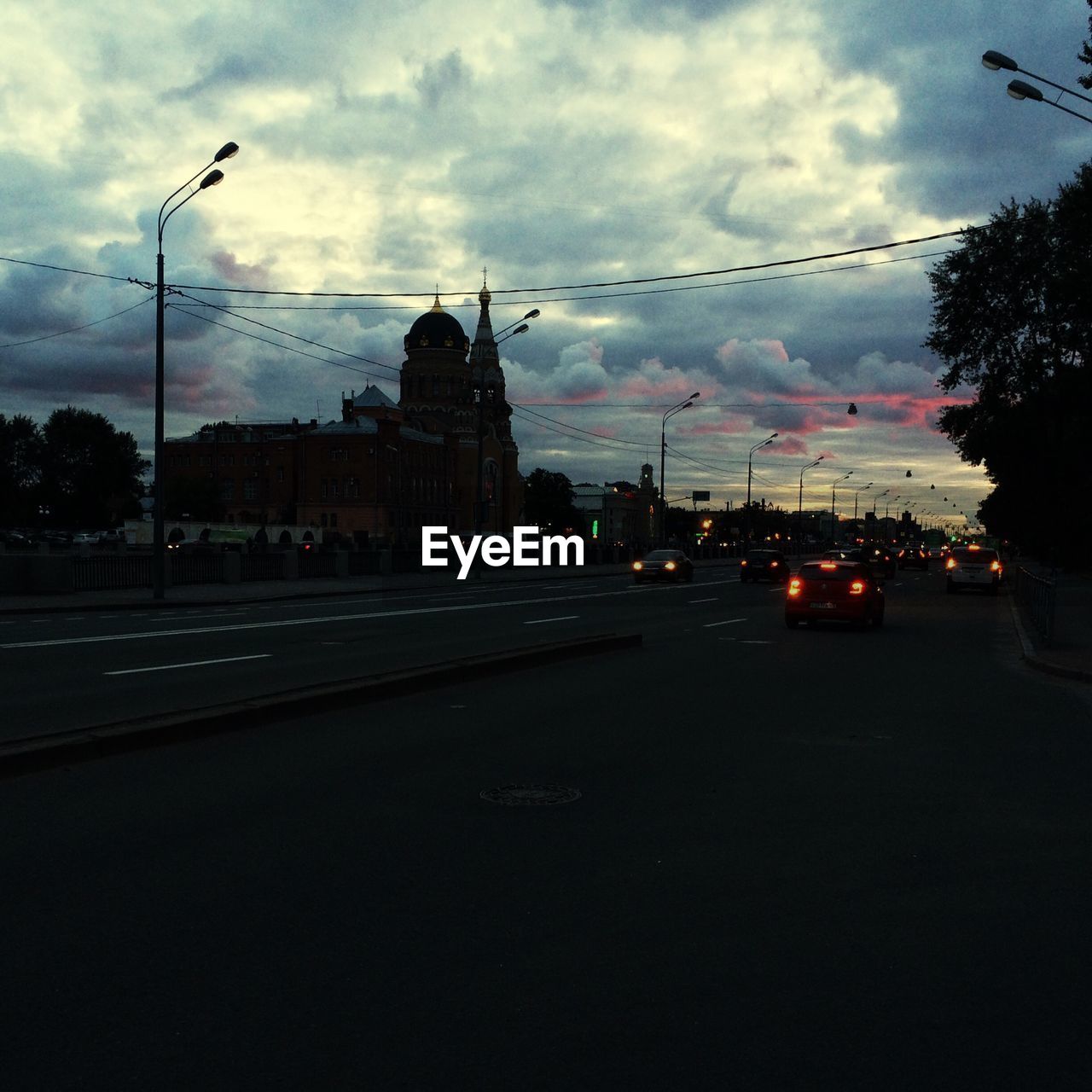 CARS ON ROAD AGAINST SKY