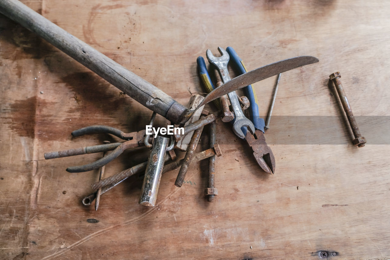 Directly above shot of rusty work tools on wooden table