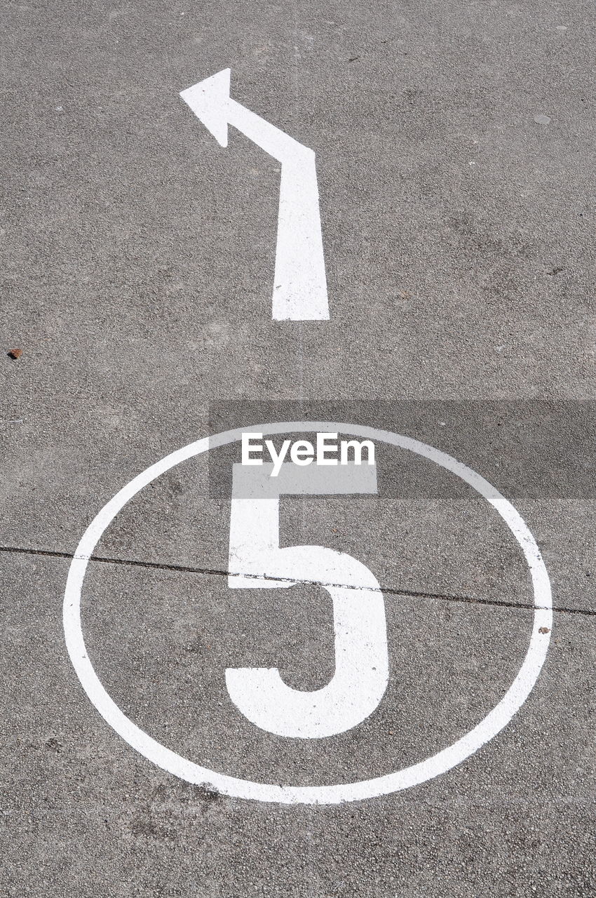 High angle view of road sign on street