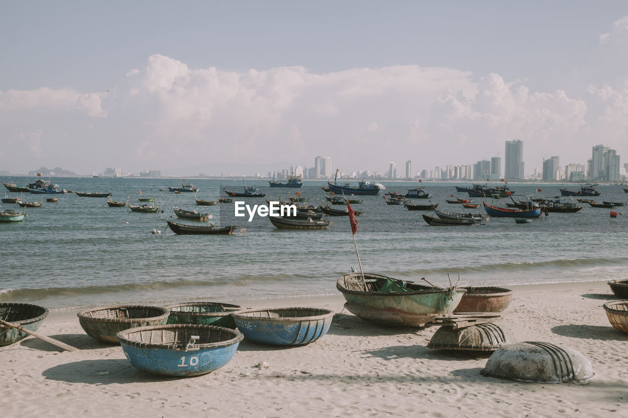 Boats moored in sea against sky