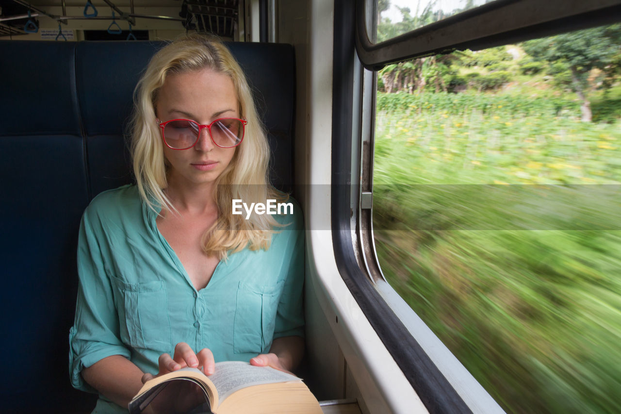 Portrait of woman sitting in train