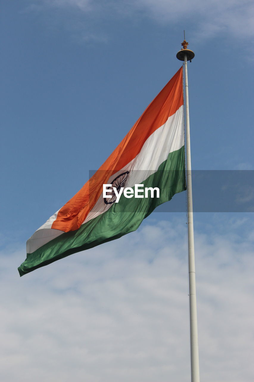 Low angle view of indian flag waving against sky