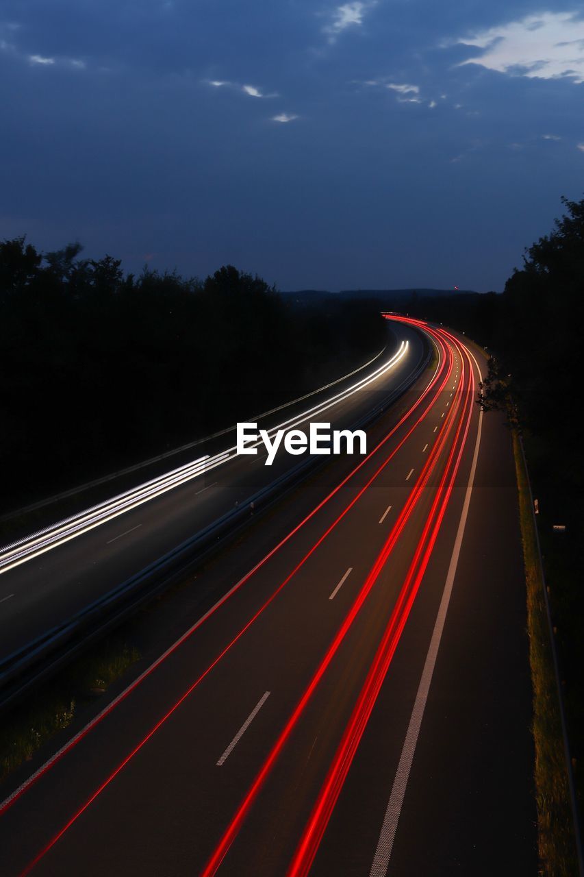 High angle view of light trails on road at night