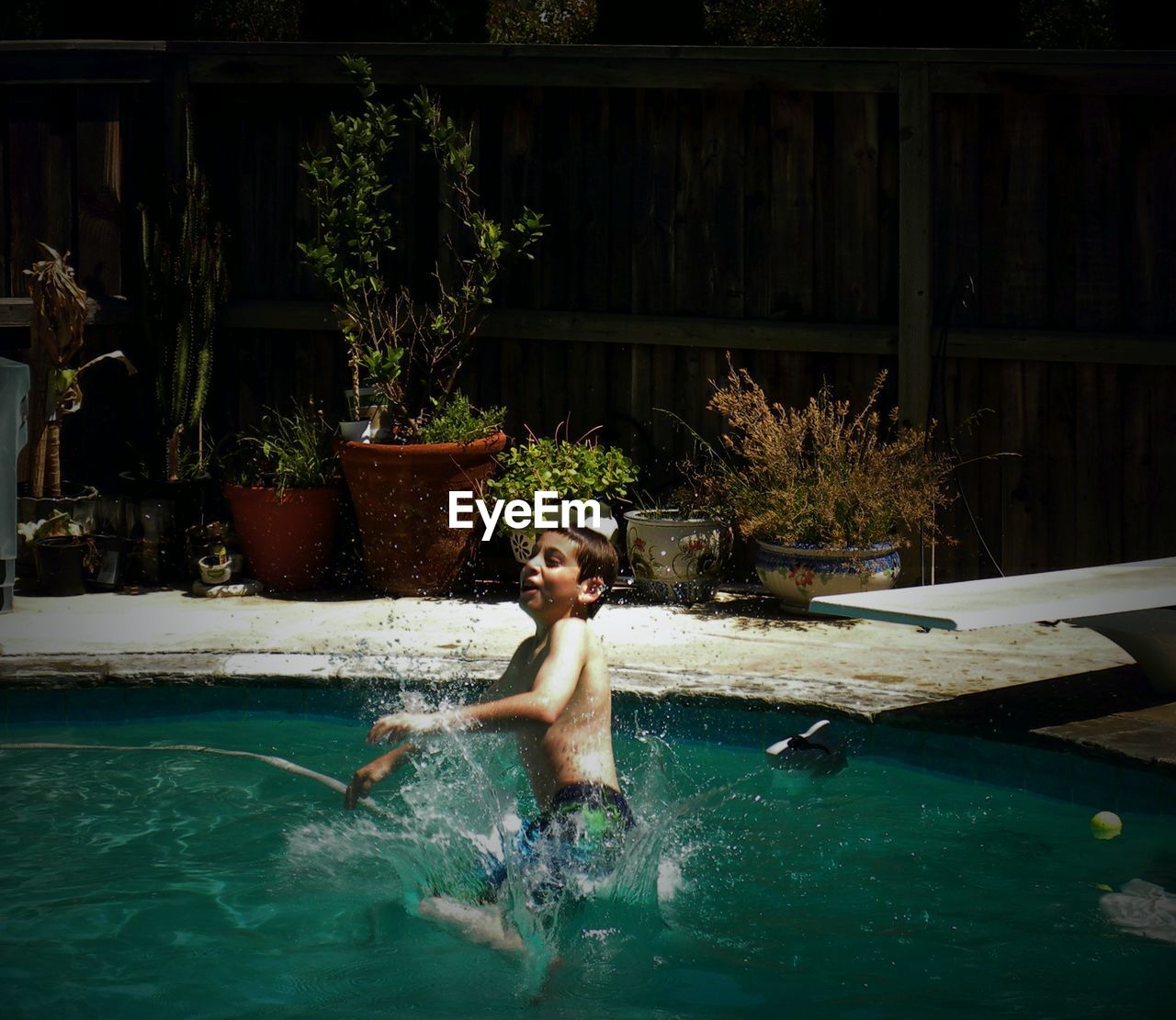 Side view of boy enjoying in swimming pool