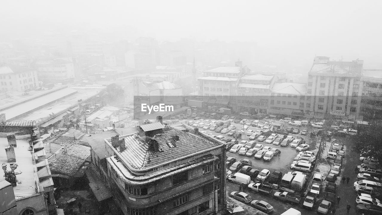 HIGH ANGLE VIEW OF CITYSCAPE IN FOGGY WEATHER