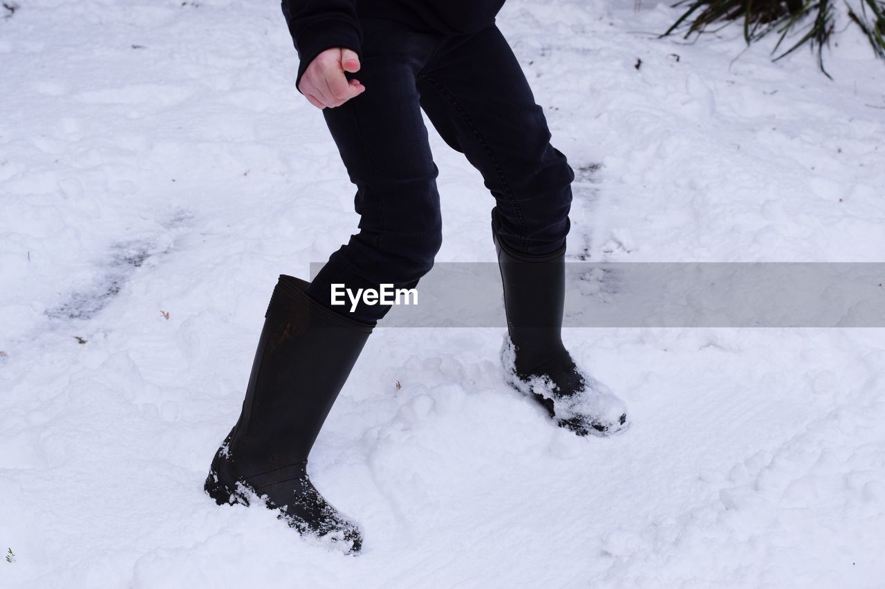 Low section of person on standing snow field