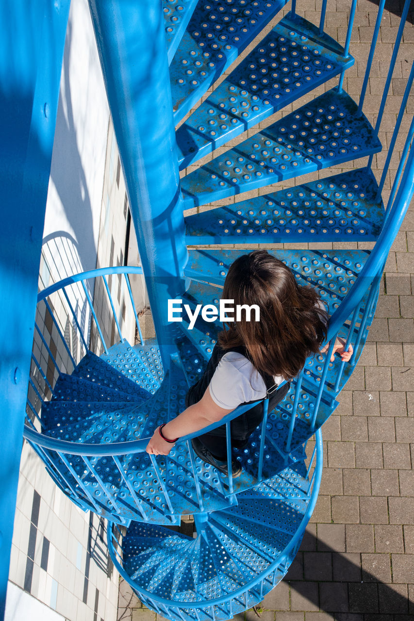 Rear view of girl on staircase