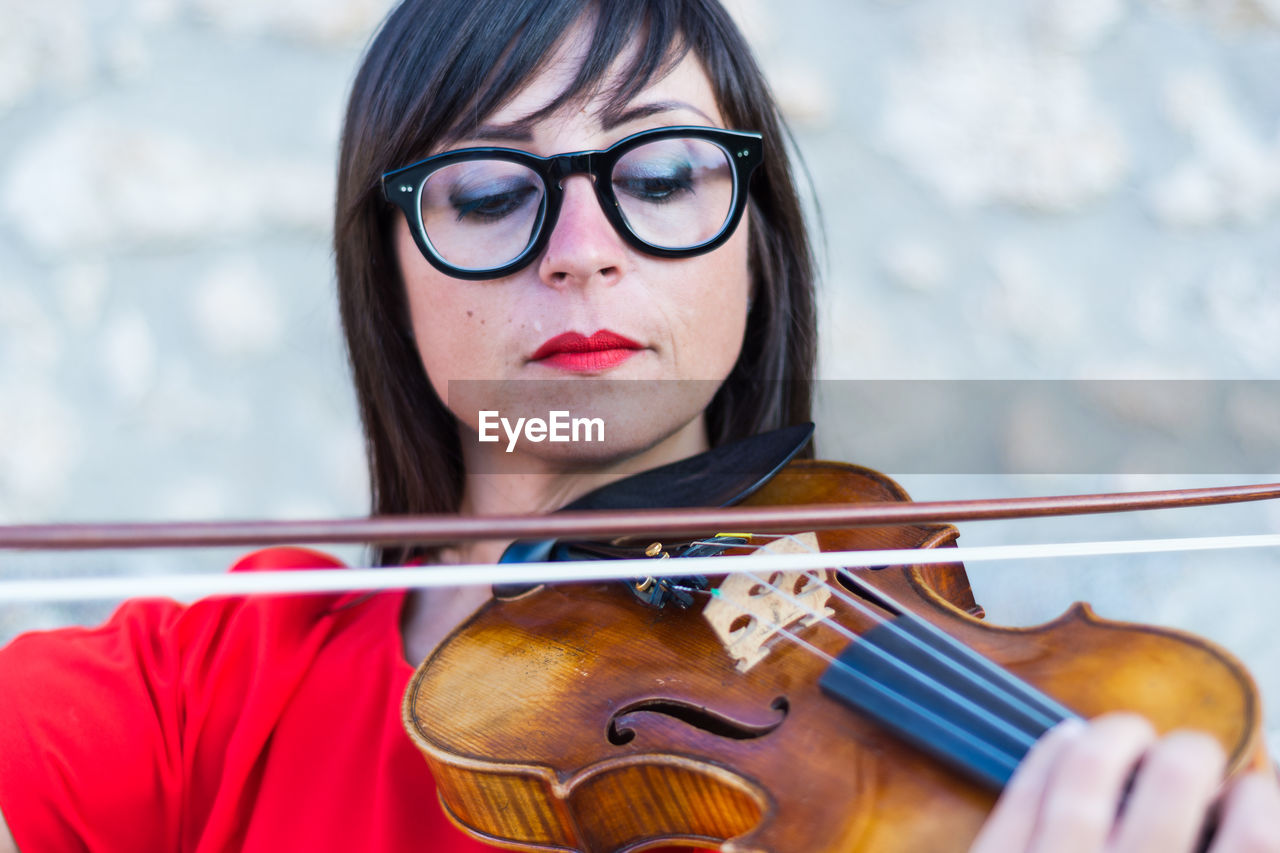 Close-up of woman playing violin