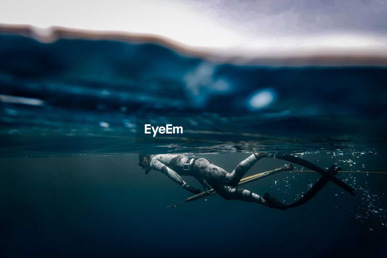 Mid adult man swimming in sea