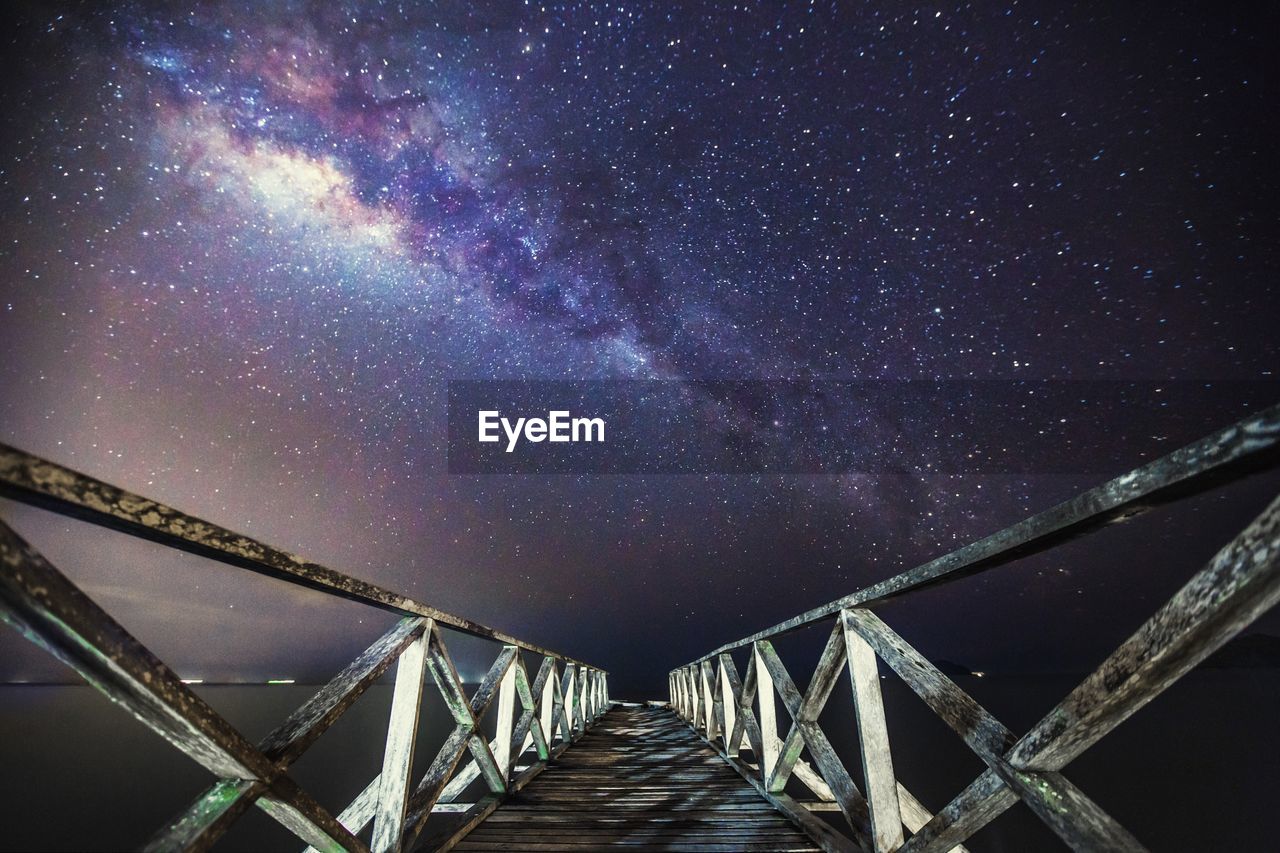 Footbridge against milky way at night