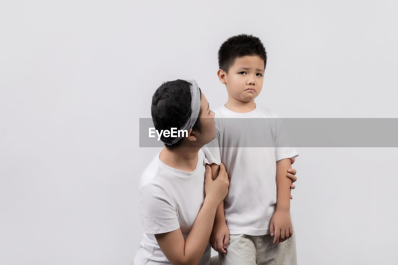 FULL LENGTH OF A BOY AGAINST WHITE BACKGROUND