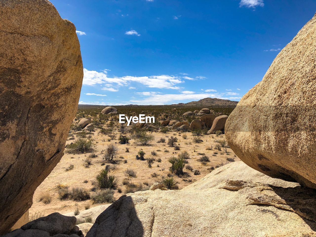 Desert view between boulders in joshua tree national park in california
