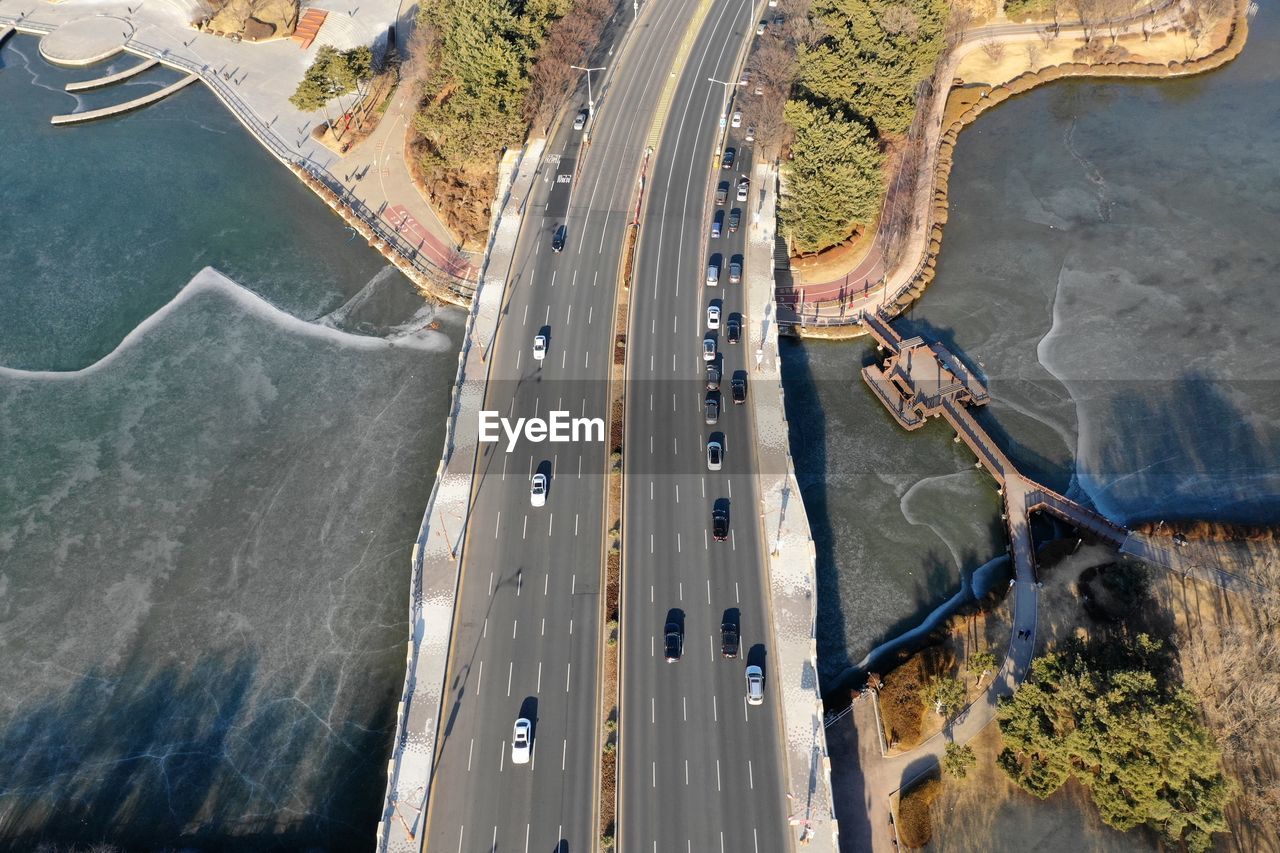 Aerial view of vehicles on bridge over river
