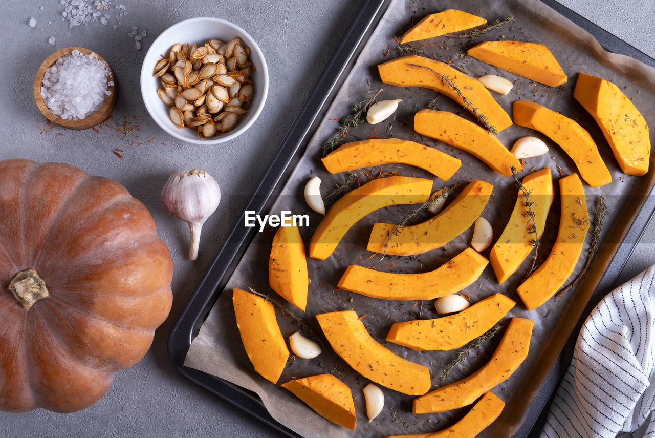 food, food and drink, freshness, produce, healthy eating, vegetable, high angle view, kitchen utensil, no people, sweet food, pumpkin, wellbeing, baked, indoors, still life, directly above, dish, snack, studio shot, ingredient, plant, fruit, spice, dessert, eating utensil, table, sweet, meal