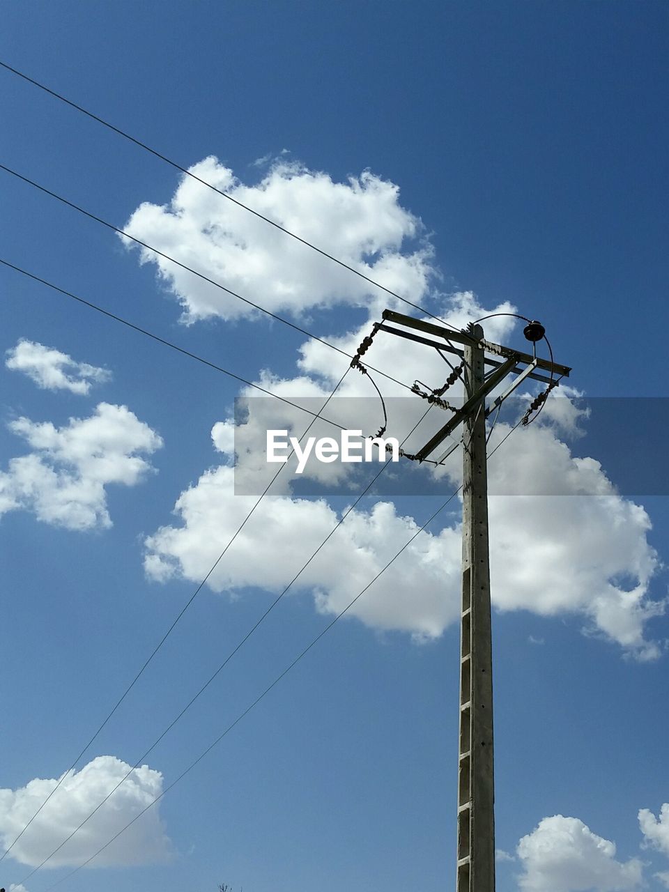 Low angle view of telephone line against blue sky